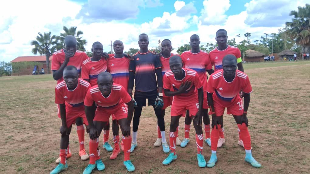 Katrini Secondary School football team in red kit on the playing field